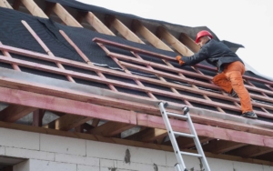 Commercial roofing worker installing the base of a roof
