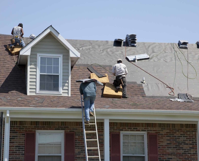 Group of roofers installing a new roof on a home