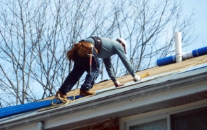 Roofing worker making repairs to a residential house