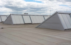 Large grey commercial rooftop during the day