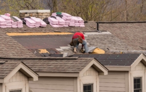 Roofing worker performing a replacement on house