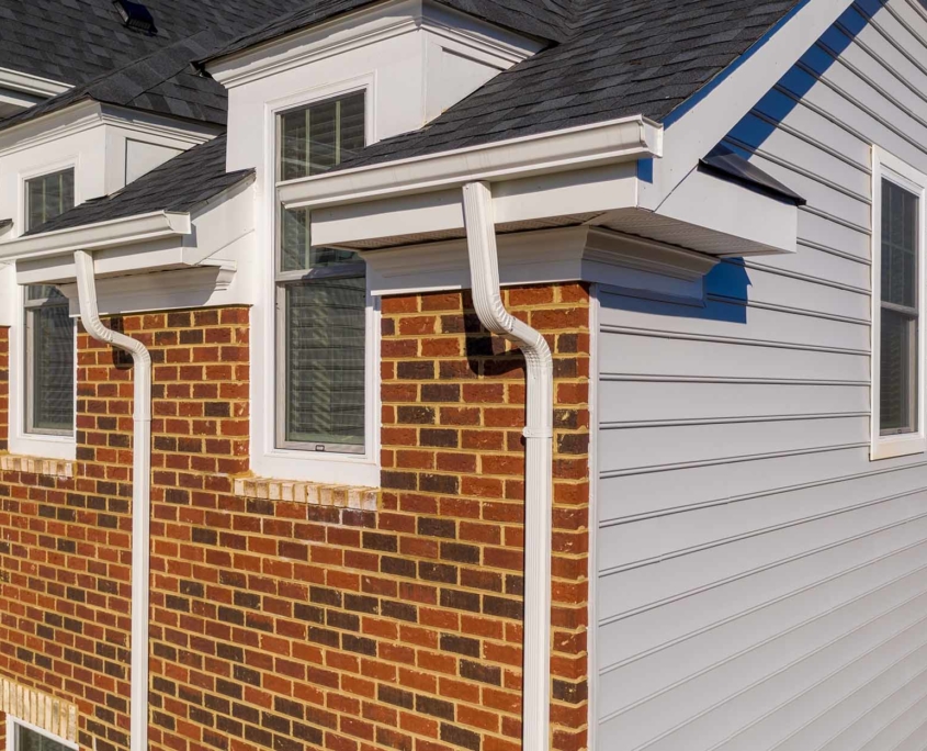 Side view of a house with mulltiple gutter systems