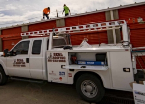 Seal roofing truck in front of a storage unit