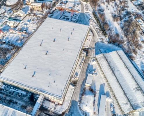 Birds eye view of a snowy commercial building roof