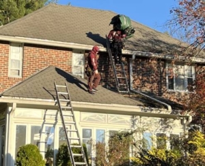 Roofers on a residential shingle roof