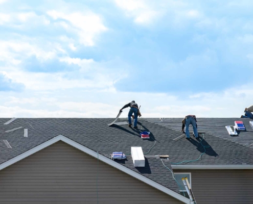 Roofers working on residential roof