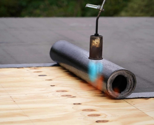 Roll of tar paper with gas burner above