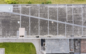 gray flat roof of an industrial building or warehouse. aerial top view