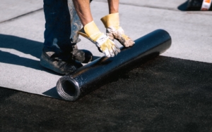Image of a worker repairing a flat commercial roof